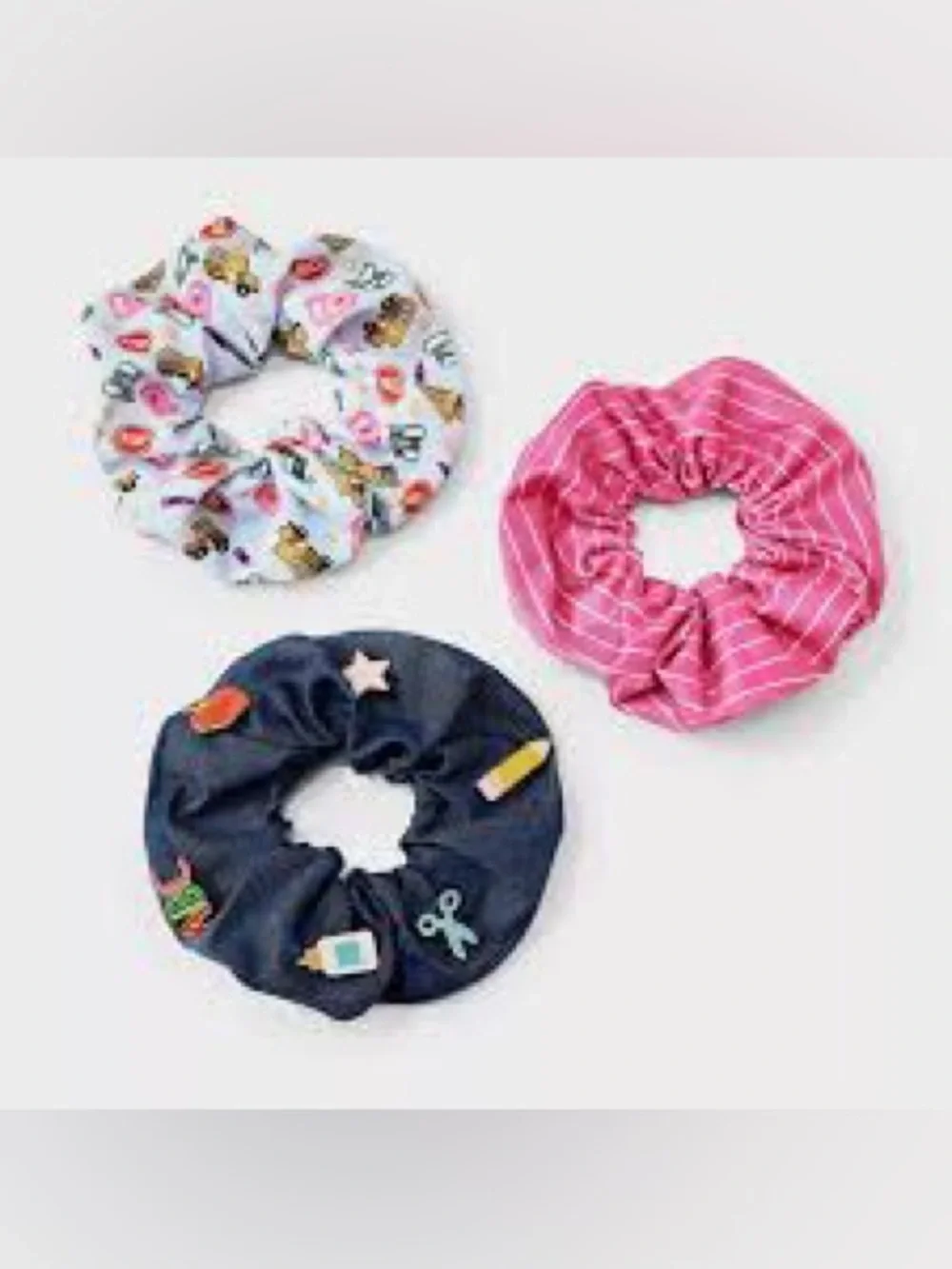 This is a 3-pack of themed hair scrunchies designed with school-related motifs.